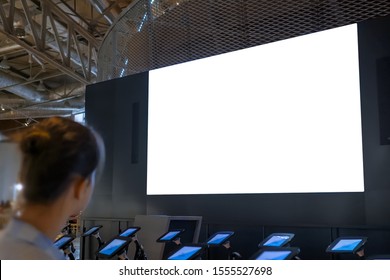 White Screen, Technology, Isolated, Futuristic, Template, Mock Up, Education Concept. Woman Looking At Large Blank Interactive White Display Wall At Science Exhibition, Museum Or Cinema