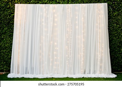 White See Through Fabric Curtain Decorate With The Lights In Wedding Ceremony. Wedding Backdrop.