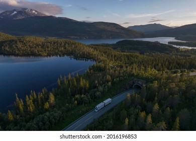 White Semi Truck on the Scenic Nordland Norwegian Road During Midnight Sun Aerial Photo. Lakes, Mountains and the Tunnel. Transportation Industry. - Shutterstock ID 2016196853