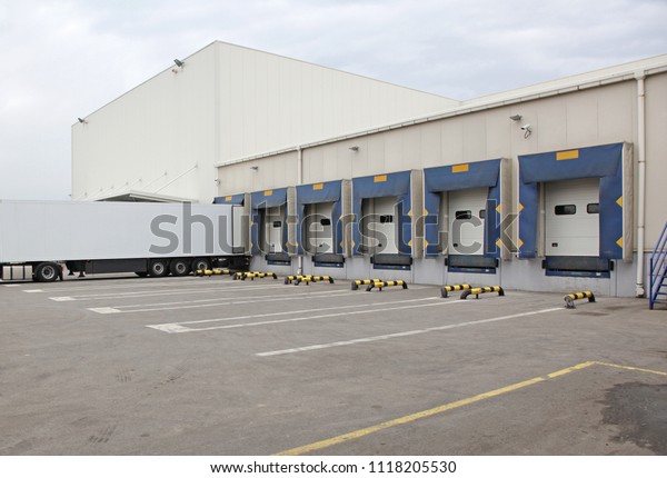 White Semi\
Truck Trailer at Warehouse Loading\
Ramp