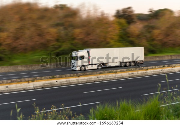 White\
semi-trailer truck for the transport of\
goods