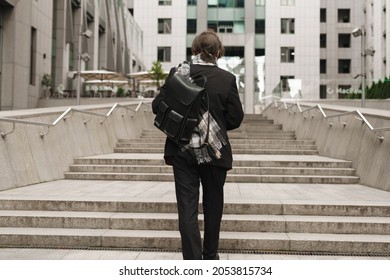 White Senior Man With Leather Backpack Going Up City Stairs Outdoors