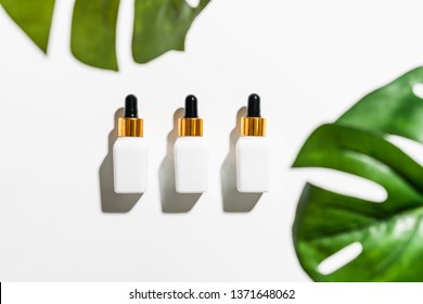 White Serum Bottle And Cream Jar, Mockup Of Beauty Product Brand. Top View On The White Background.