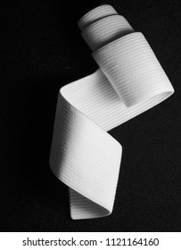 White Sewing Elastic Rolled Band On Black Background.