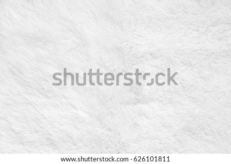 White shaggy blanket texture as background. Fluffy fake textile fur.