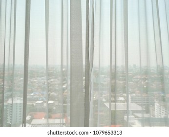 White sheer curtains with high angle view of the city - Powered by Shutterstock