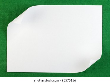 White Sheet Of Paper With Curled Edge On Green Background