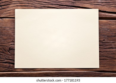 White Sheet Of Paper On Old Wooden Table.