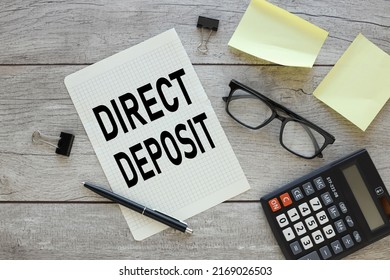 A White Sheet With The Text Direct Deposit Files In An Open Notebook On A Wooden Background . The Image Of The Business Concept