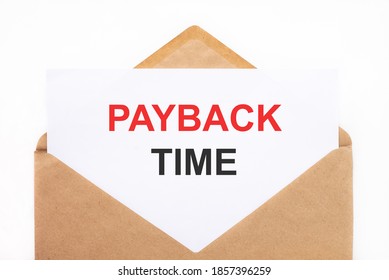 A white sheet with the text payback time lies in an open craft envelope on a white background with copy space. Business concept image