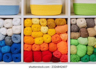 White shelving with colored balls of yarn for knitting. Bright yarn balls lined up on the shelves. Organizing and storage in craft room. Handmade, needle craft, creativity and  hobby.  - Powered by Shutterstock