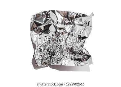 White Shiny Aluminum Foil Wrap Without Chocolate Candy On A White Background. Texture Of Used Crumpled Aluminium Food Foil.