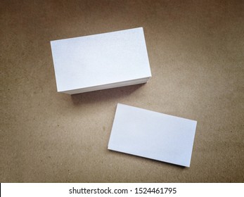 White Shiny Business Cards On A Brown Vintage Surface, Top View. Design Business Card Template, Sirio Pearl Ice Paper, Beautiful Mockup