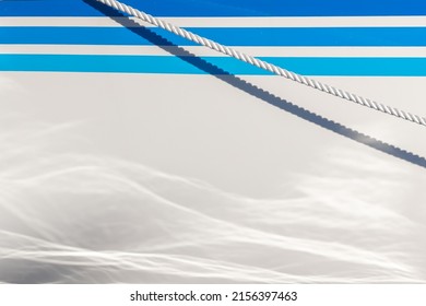 White Ship Hull With Blue Lines And Clean White Rope With Shadow. Water Reflecting On Keel. Space For Text In Warm Summer Image.