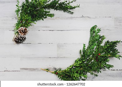 White Shiplap Board Background With Boxwood Greens And Blank Space For Adding Text