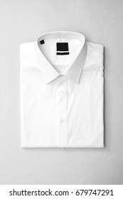 White Shirt With Blank Label On Isolated Background, Top View