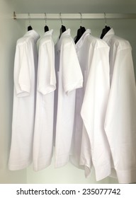 White Shirts Hanging On Cloths Racks