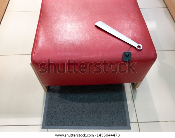 White Shoe Horn Lies On Red Stock Photo 