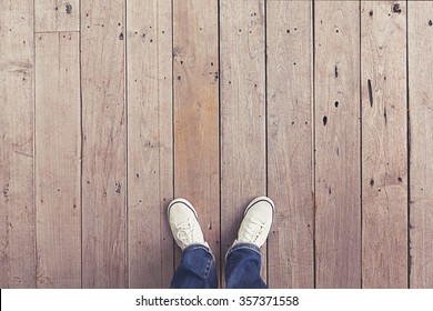 White Shoes On Wooden Planked Floor From Above