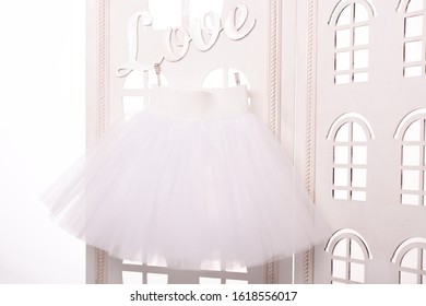 white short tulle skirt on a white background, glowing background, 
ballet tutu, white tutu skirt, love