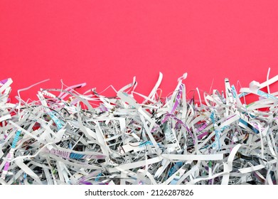 The White Shredded Paper On Red Background.