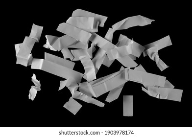 White shredded paper scraps, strips isolated on black background with clipping path, top view - Shutterstock ID 1903978174