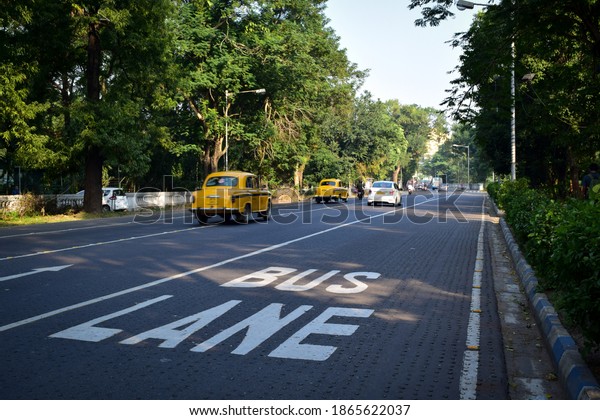 The white\
sign BUS LANE painted on the asphalt road. Selective focus on the\
sign. Kolkata, India - 29th November,\
2020.