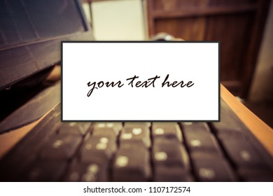 white sign with texture of an old computer keyboard in the background