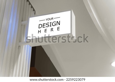 White signage mockup on a wall. Mockup sign outside of a shop. White Square Sign With Blank Space For Logo On The Marble Wall Mock Up