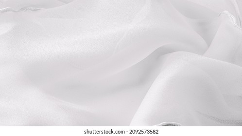 White silk organza with wavy piping. Border around the edge of the fabric. Abstract background. texture pattern. Silk organza has a delicate open weave. Wave background. Copy space