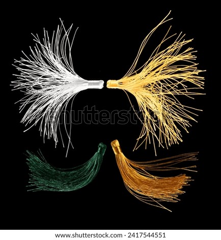 White Silk Tassel for decorating. Indian culture hang Tassel for moving wind blow and elegance look. Tassel has many color spinning in air. Black background isolated freeze motion