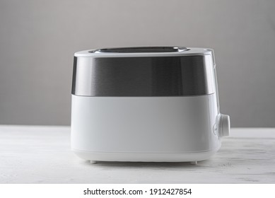 White With Silver Toaster On Gray Background