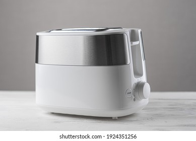 White With Silver Toaster On Gray Background