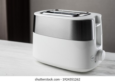 White With Silver Toaster On Gray Background