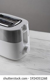 White With Silver Toaster On Gray Background