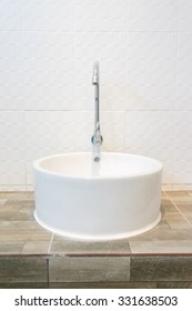 White sink and chrome faucet with white tiles