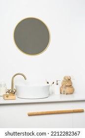 White Sink On Marble Counter With A Round Mirror Hanging Above It. Bathroom Interior. Copy Space