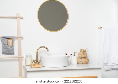 White Sink On Marble Counter With A Round Mirror Hanging Above It. Bathroom Interior. Copy Space