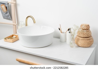 White Sink On Marble Counter With A Round Mirror Hanging Above It. Bathroom Interior. Copy Space