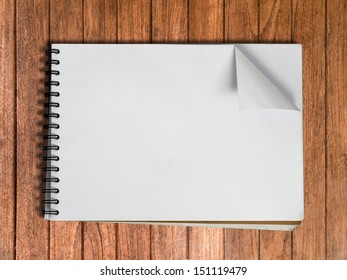 White Sketch Book One Page On Wood Table Background