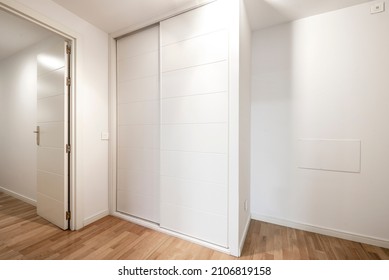 White Sliding Door Wardrobe With Oak Parquet Flooring