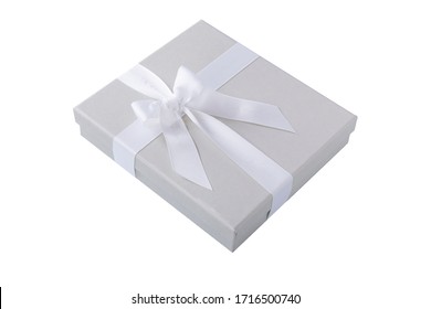 A White Small Square Gift Box With A White Ribbon Isolated On White Background.