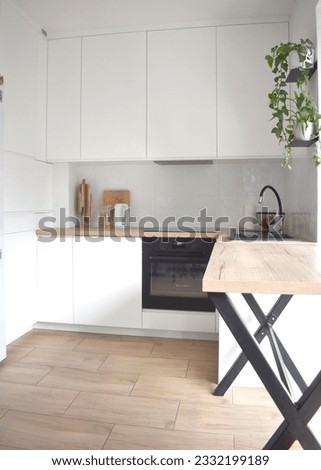 white small u shaped kitchen with wood top