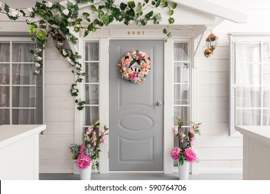 White Small Wooden House With Gray Door. Spring Flower Decoration