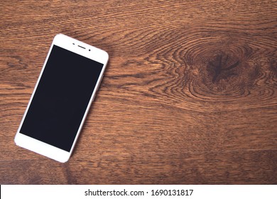 White Smart Phone On The Table Background