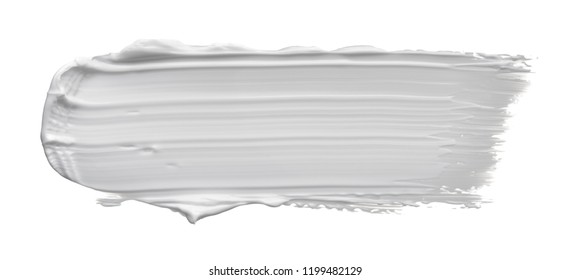 White smear of cosmetic cream or white acrylic paint isolated on white background.