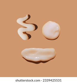 White сosmetic smears of sunscreen creamy texture on a pastel background in the shape of smiley and smiling face. SPF sunblock cream. Cream mockup. Natural skin care concept