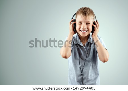 Excited child listening to music with headphones