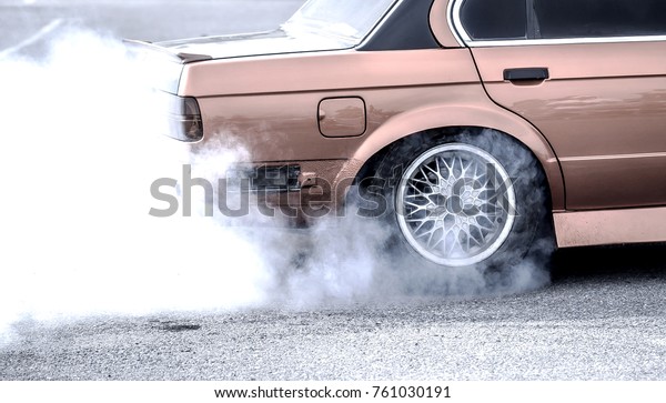 White smoke around the\
drifting car