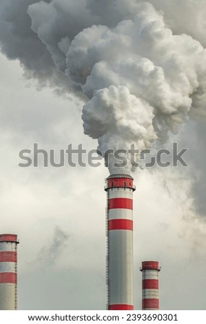 White smoke from big red chimneys in cold cloudy autumn fresh day